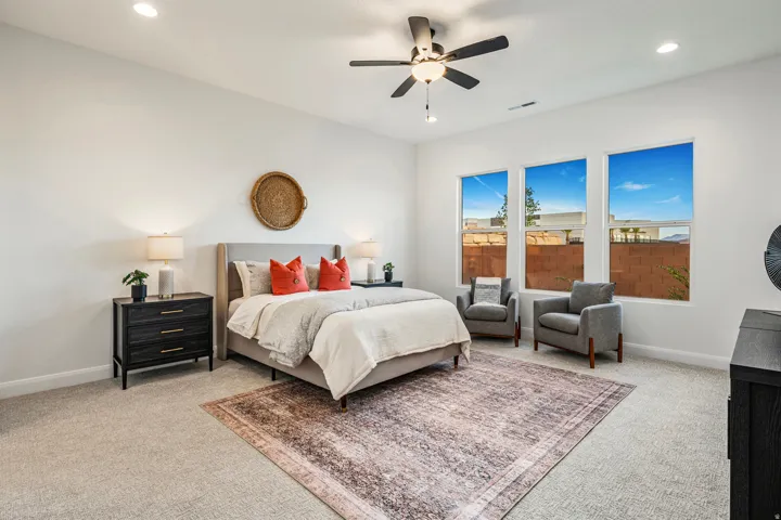 Spacious room featuring multiple windows, recessed lighting, a ceiling fan with integrated lighting, and light-toned carpet flooring