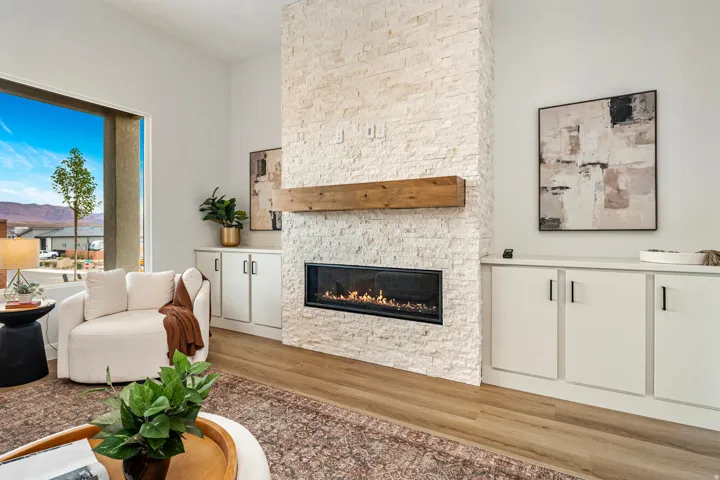 Living area featuring a floor-to-ceiling stacked stone fireplace with a wood mantle and linear hearth