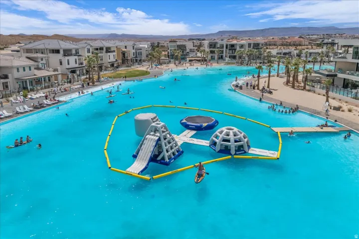 Expansive aquatic feature with clear water and inflatable water park elements