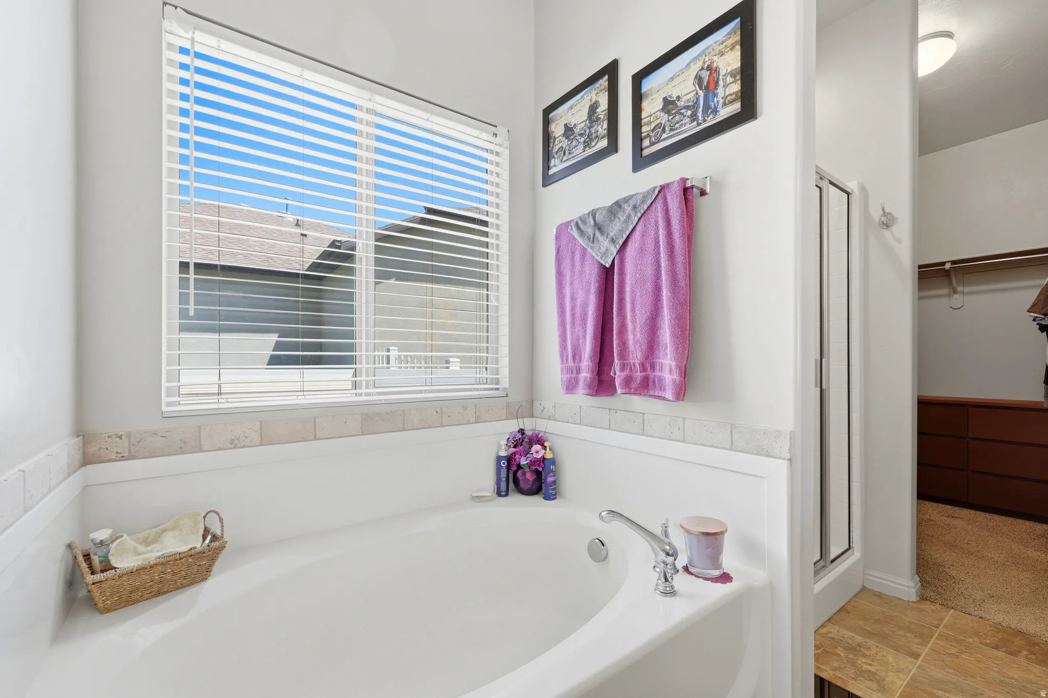 Soaking tub with a polished chrome faucet and a tiled surround