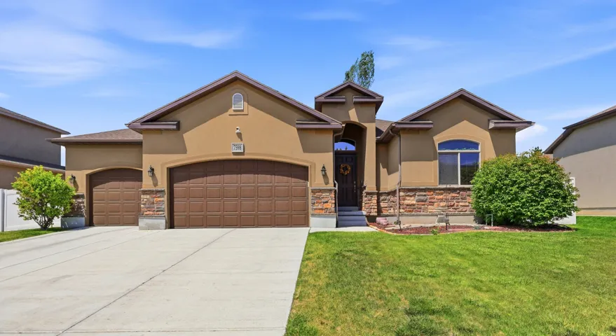 Stucco exterior with stone accents and arched entry
