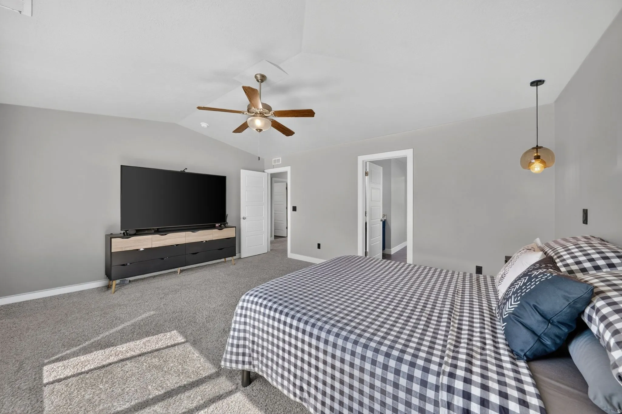 Spacious room featuring vaulted ceilings, a ceiling fan with integrated lighting, recessed lighting, and wall-to-wall carpeting