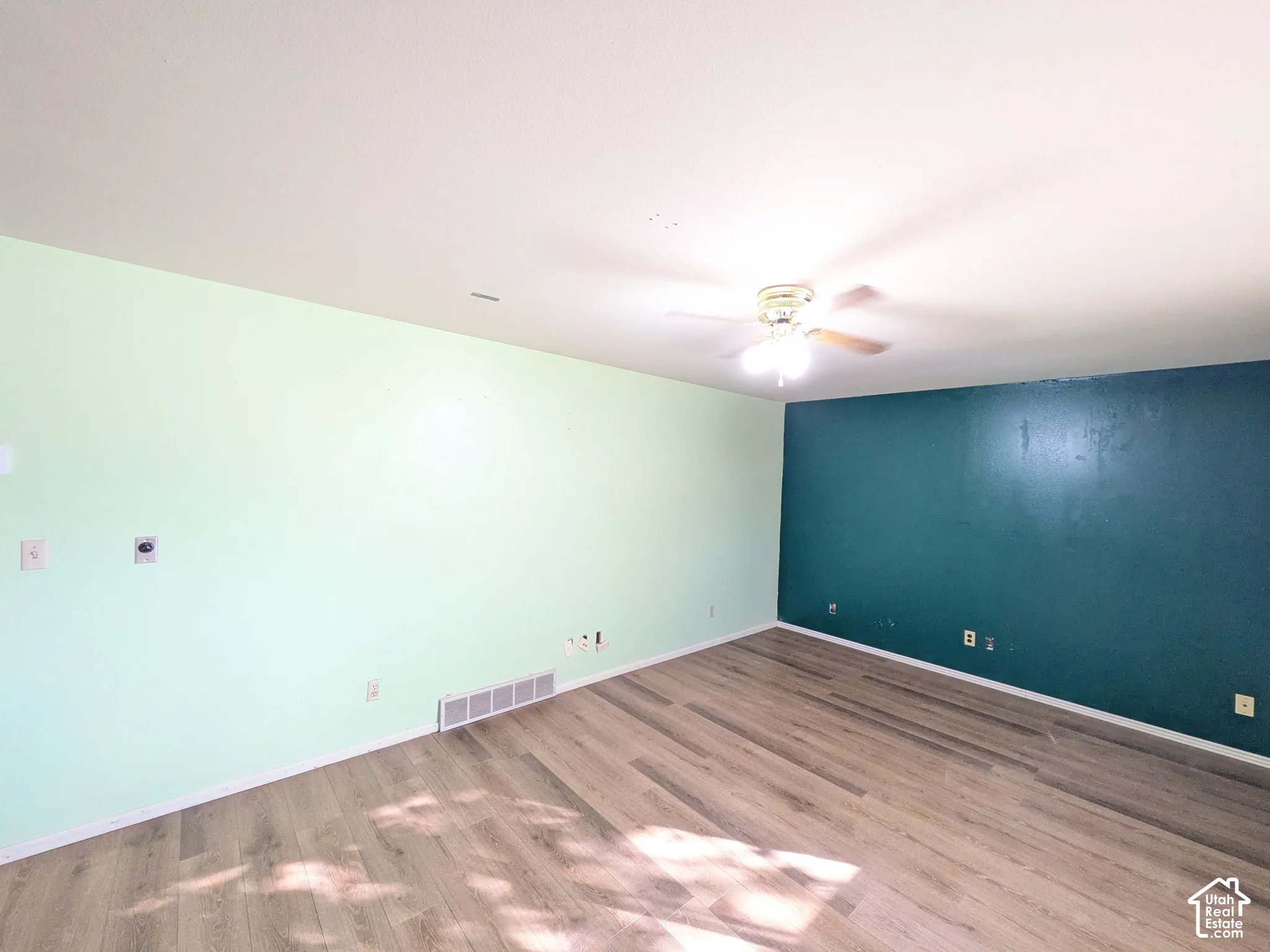Wood-finish flooring with a ceiling fan light fixture