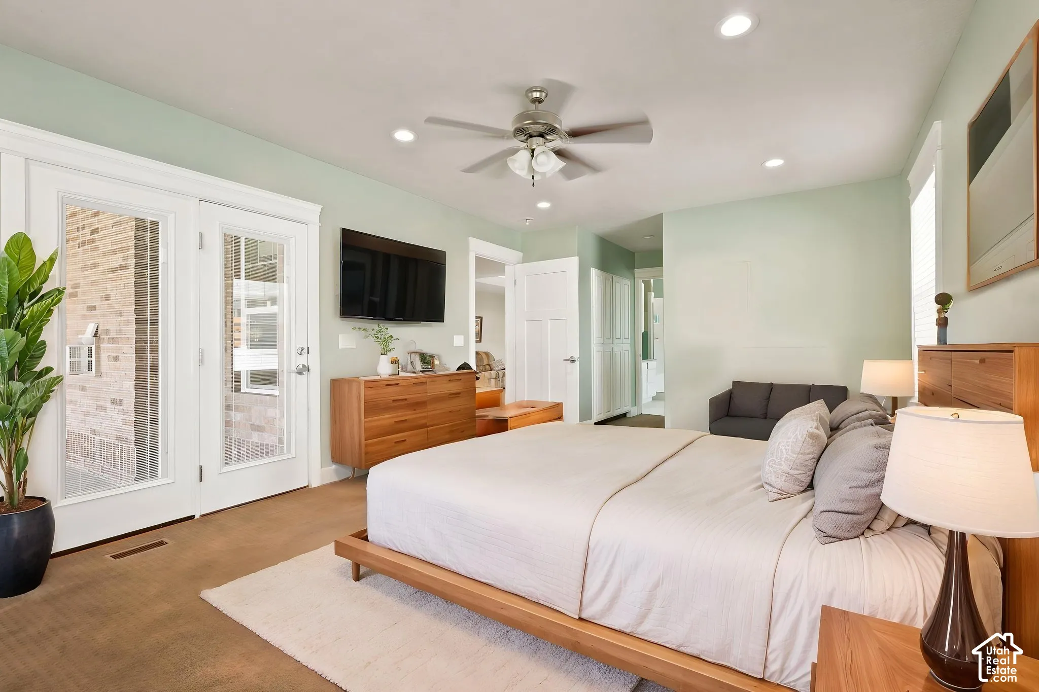 Bedroom featuring wood-finish flooring, recessed lighting, and a ceiling   Digitally staged.