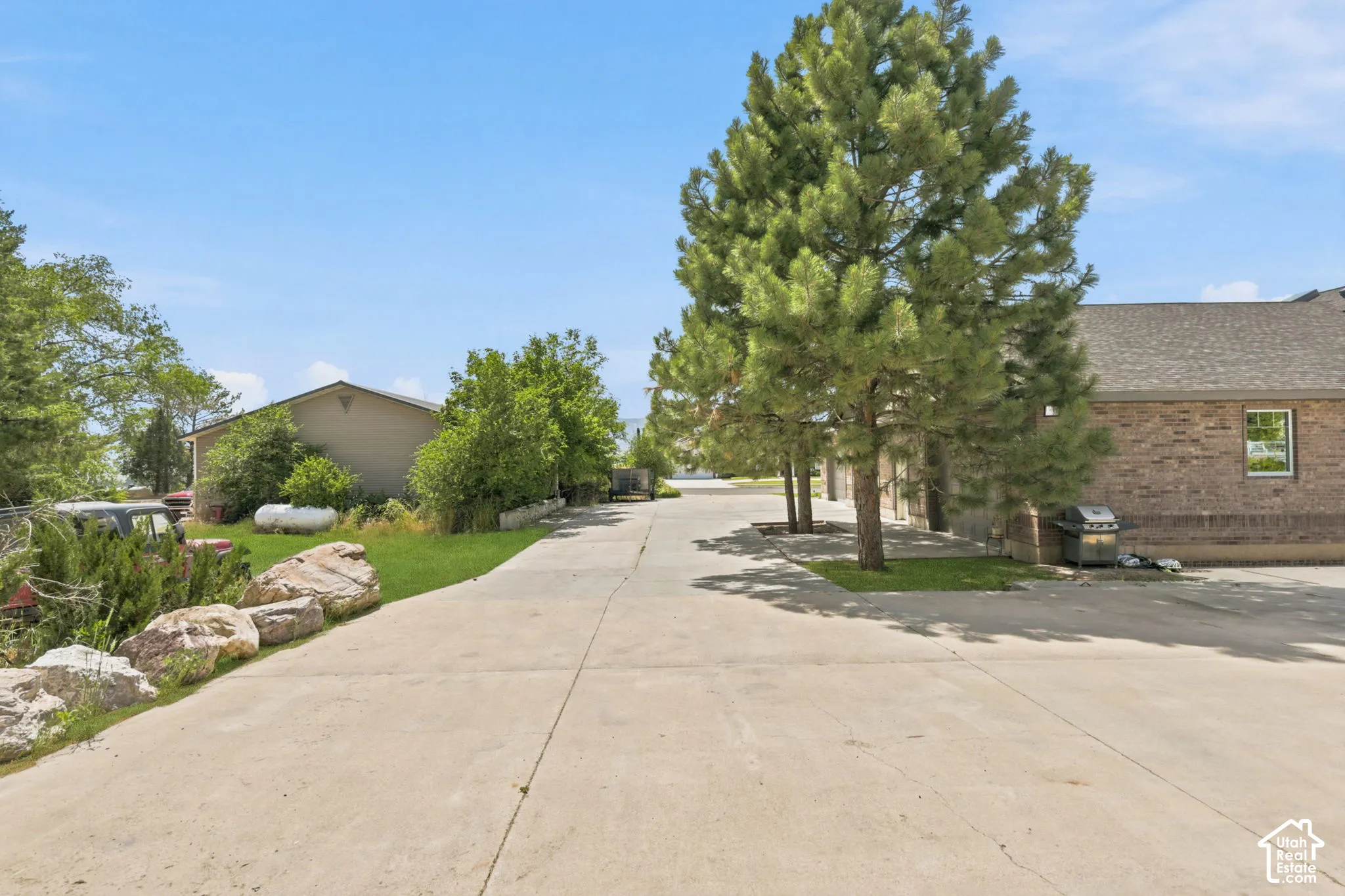 Concrete driveway with natural rock landscaping