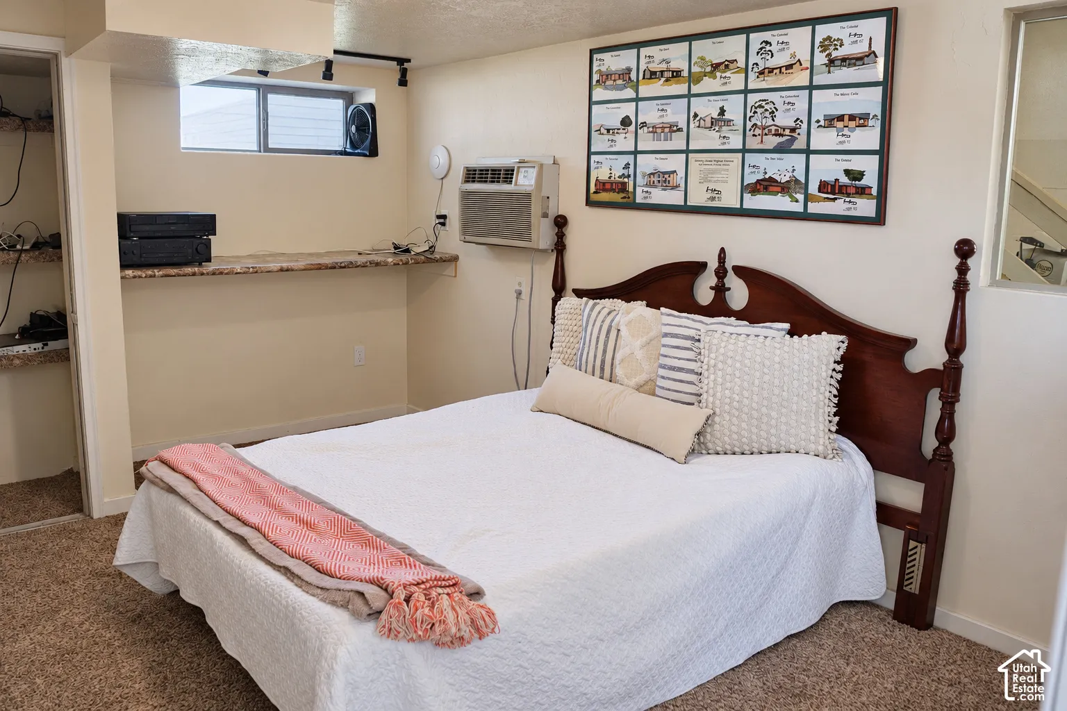 Recessed window with a granite-finish shelf, built-in shelving, track lighting, and a window air conditioning unit