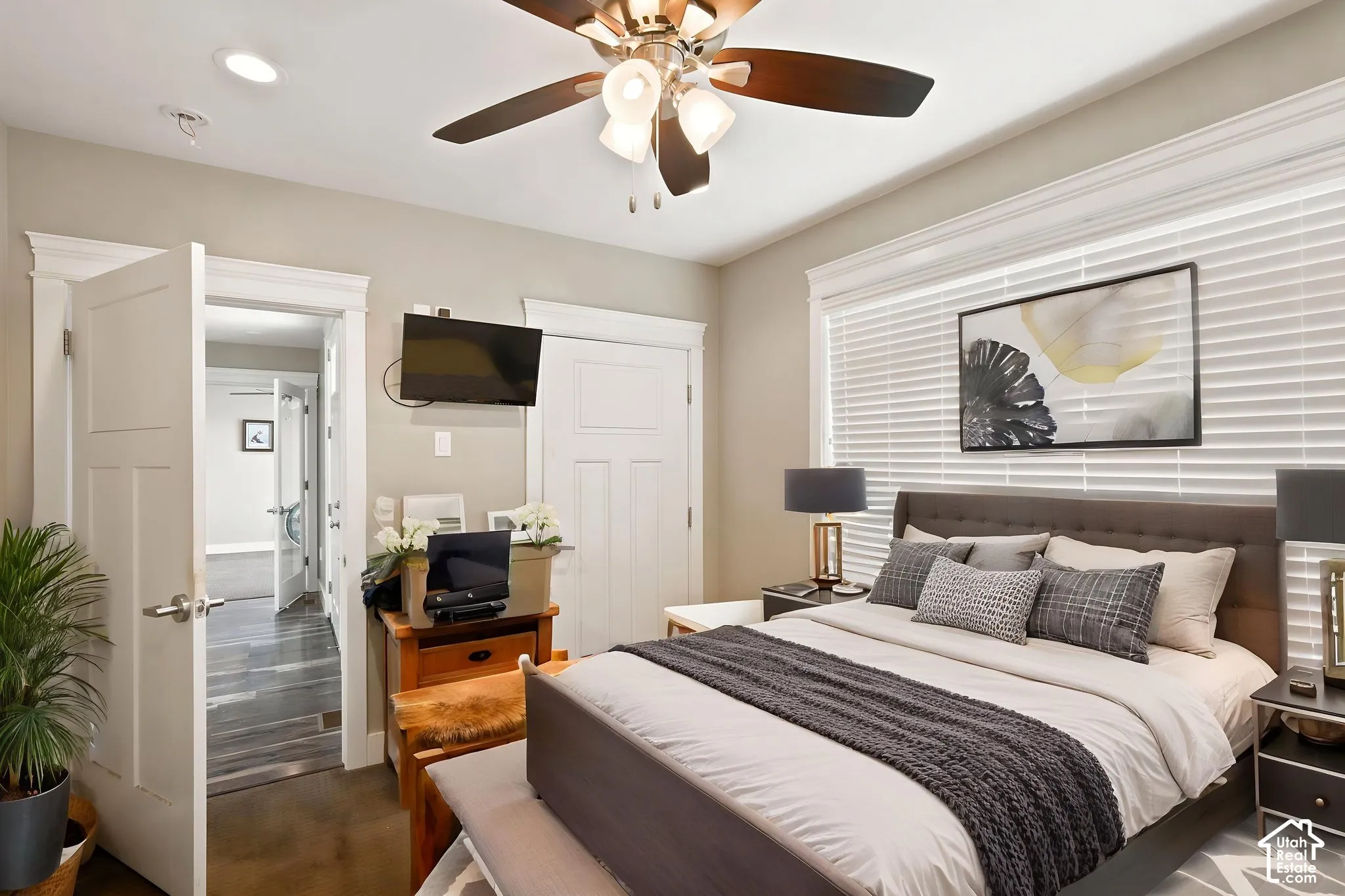 Exterior access bedroom featuring a ceiling fan with integrated lighting, recessed lighting, and a window with   Digitally staged.