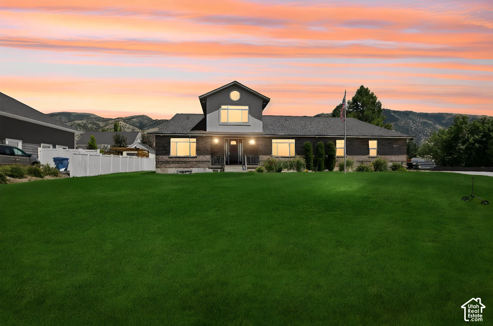 Contemporary residence featuring a brick and siding exterior, a prominent front gable, and a covered entry porch  Digitally staged.