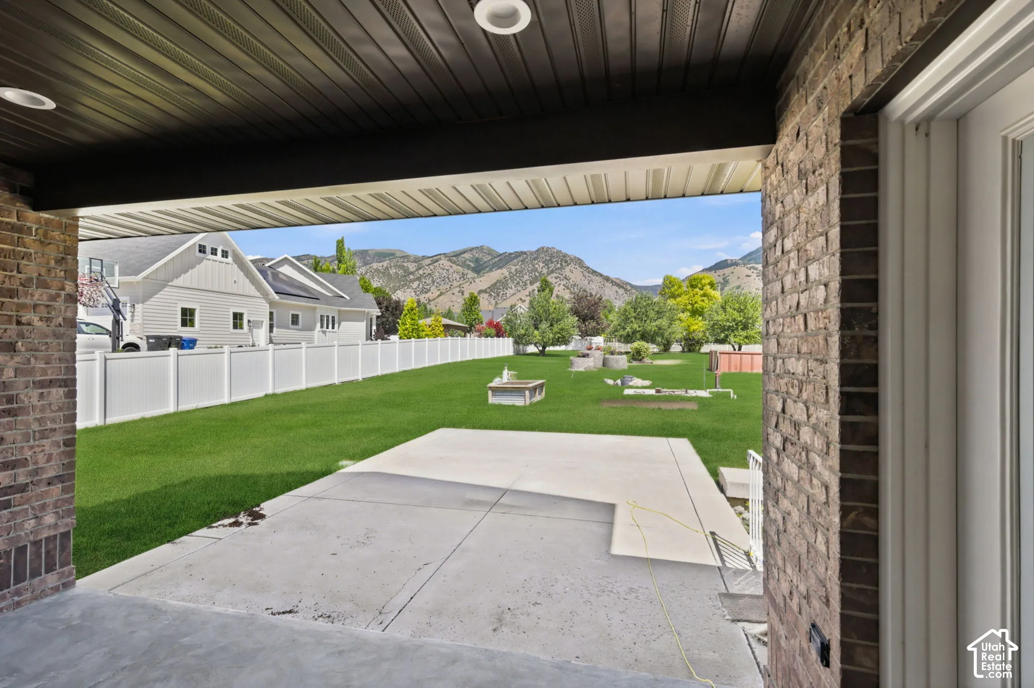 Covered patio featuring recessed lighting and a brick column