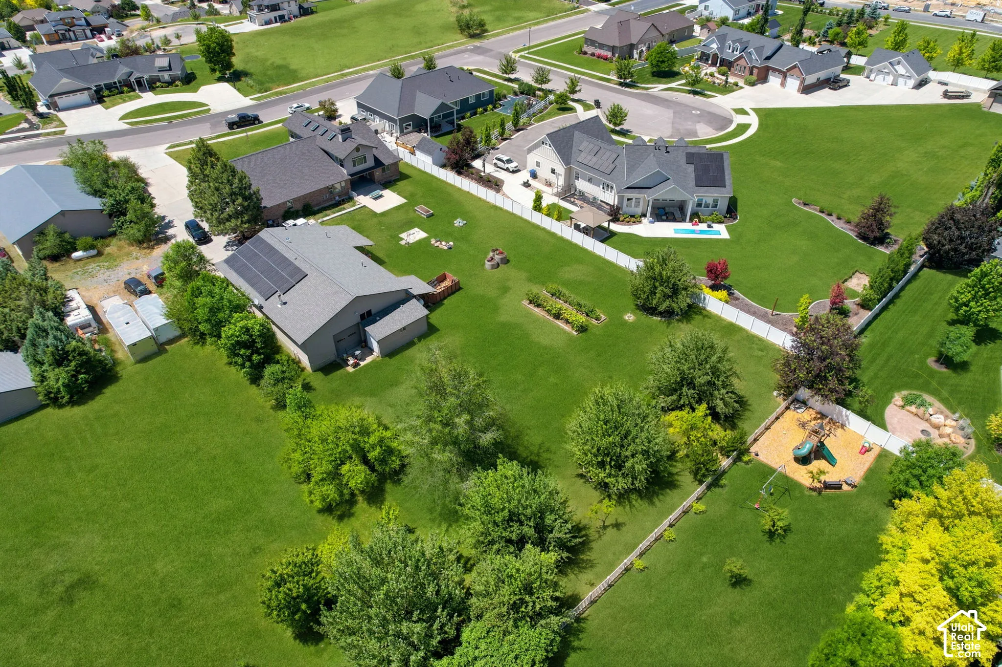 Aerial perspective showcasing a residential area with manicured lawns and mature trees