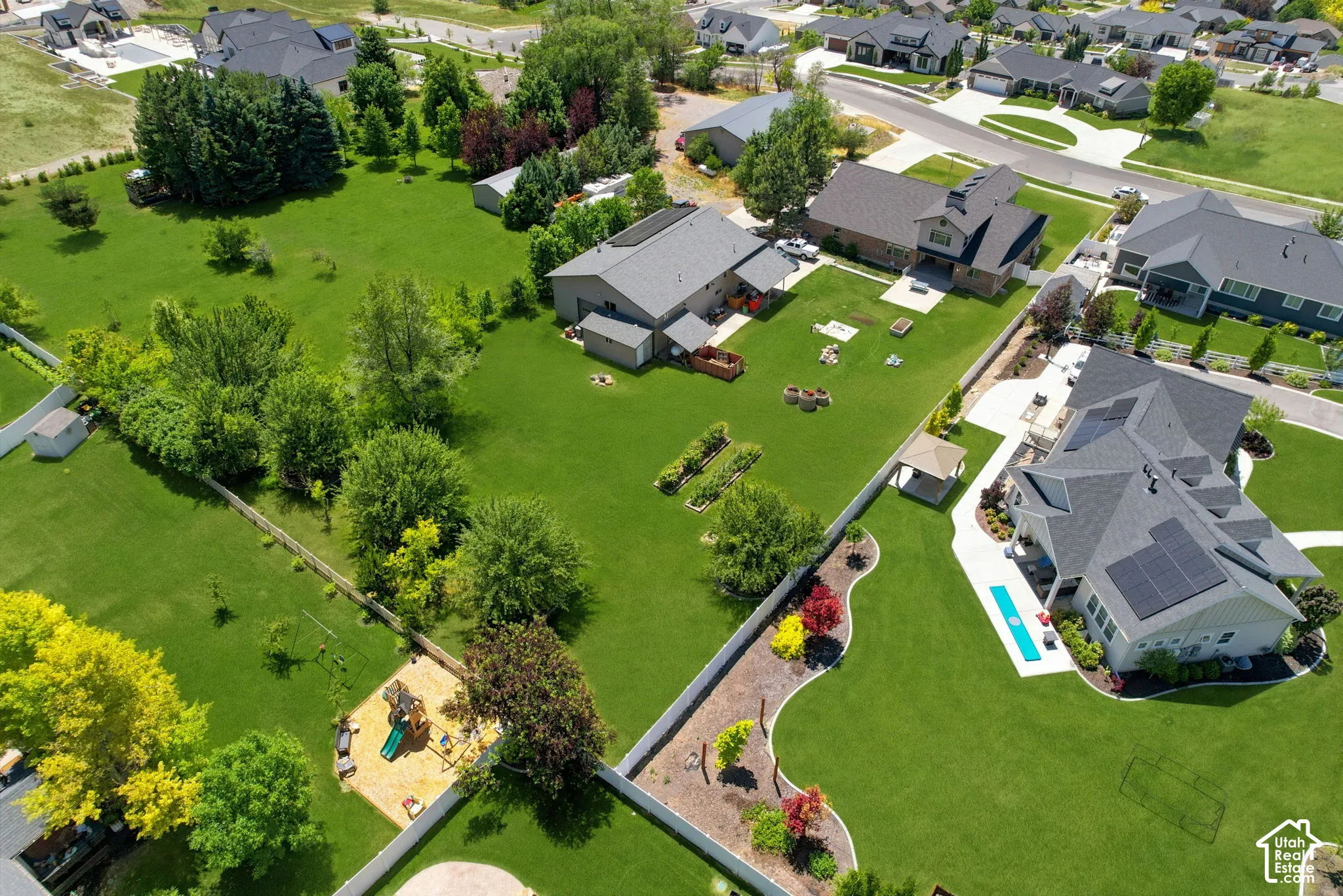 Expansive aerial capturing multiple residences and substantial green spaces