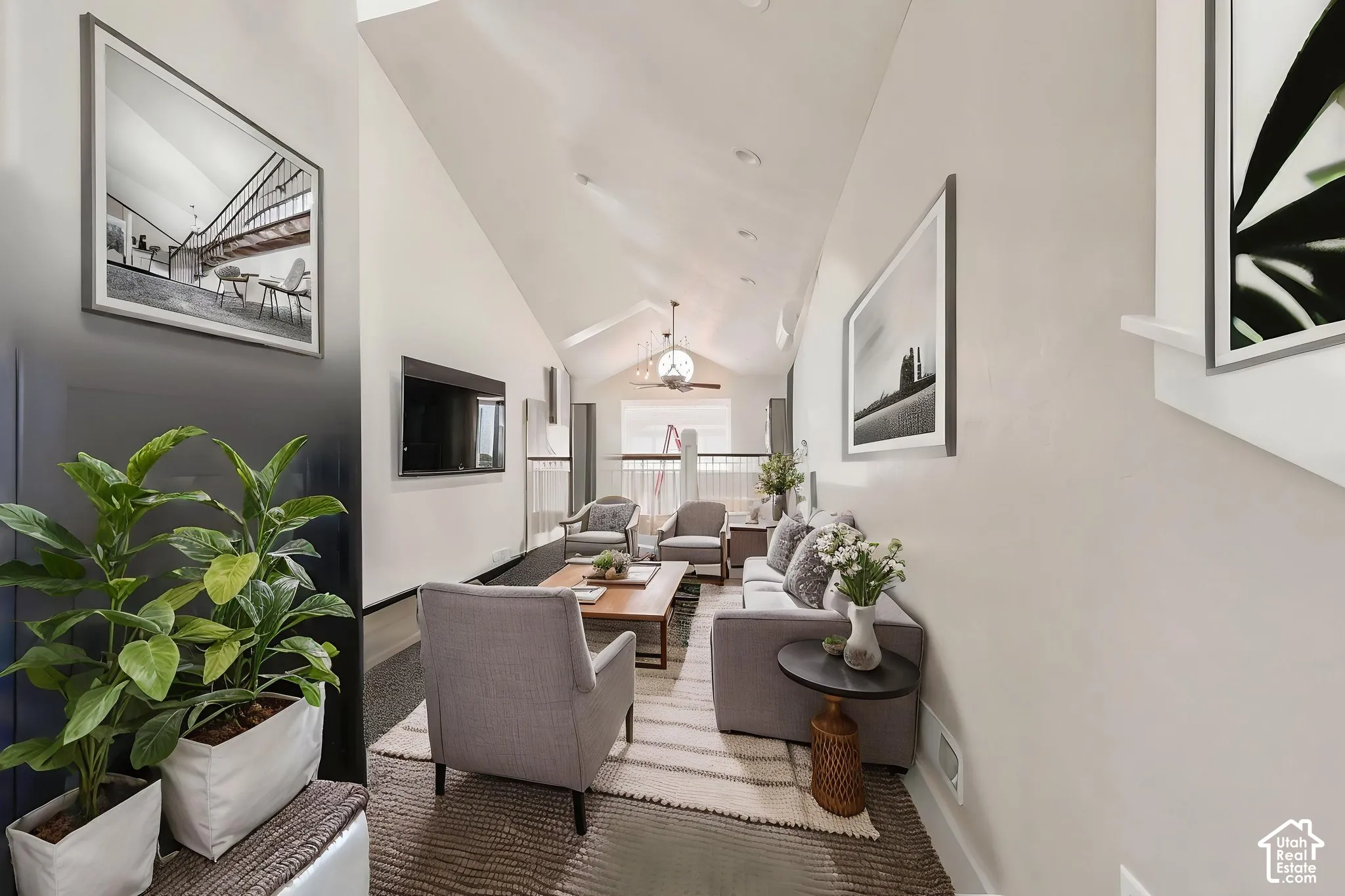 Vaulted ceiling with exposed beam, recessed lighting, and a ceiling   Digitally staged.
