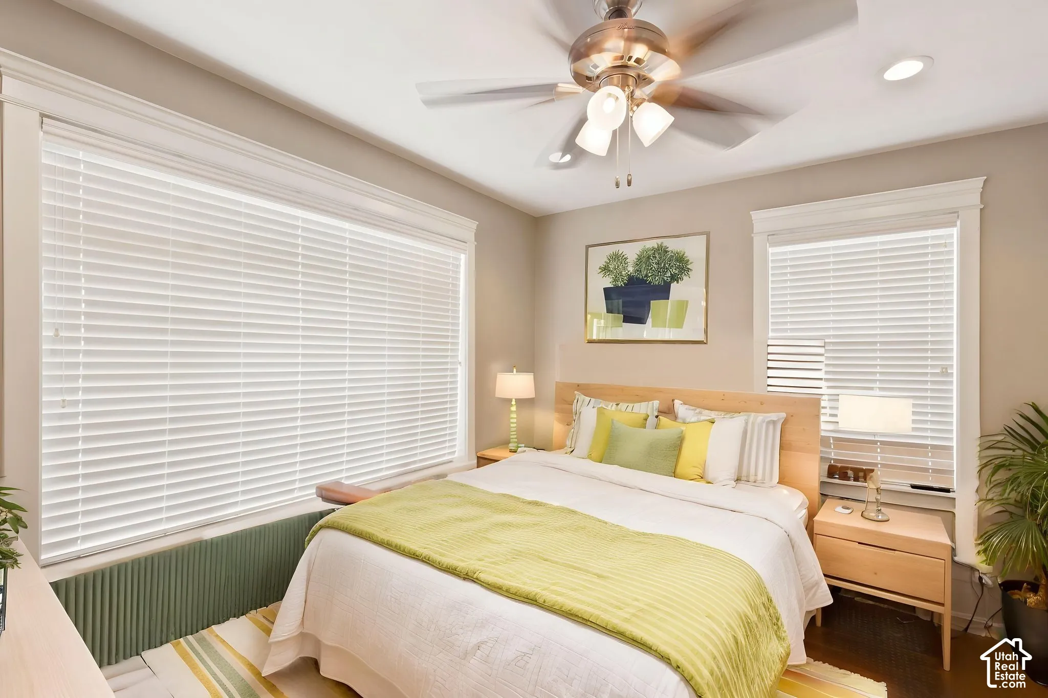 Recessed lighting, a ceiling fan with integrated lighting, and multiple windows with blinds provide ample   Digitally staged.