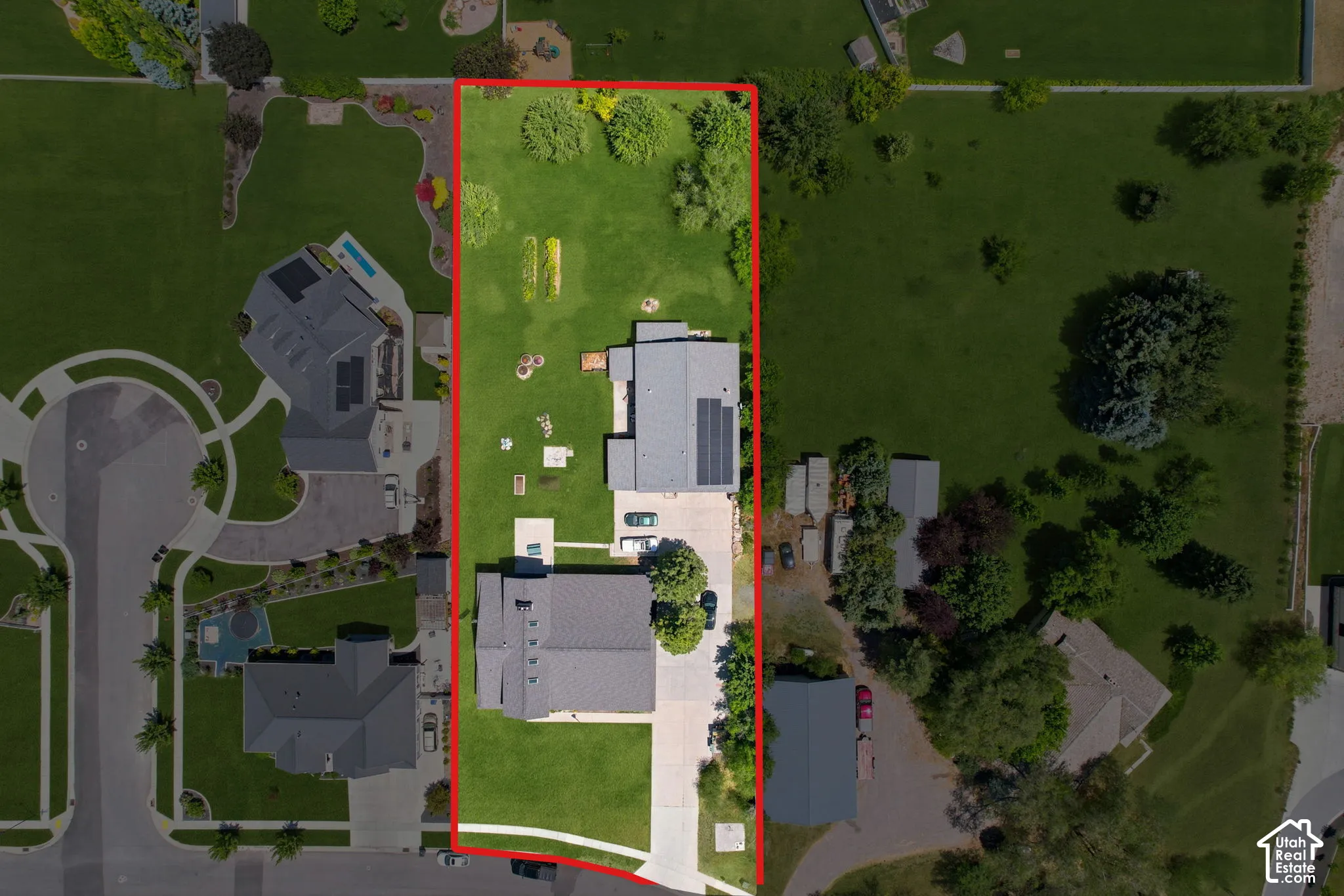 Expansive property featuring two distinct structures, a substantial grassy yard, and mature   Digitally staged.