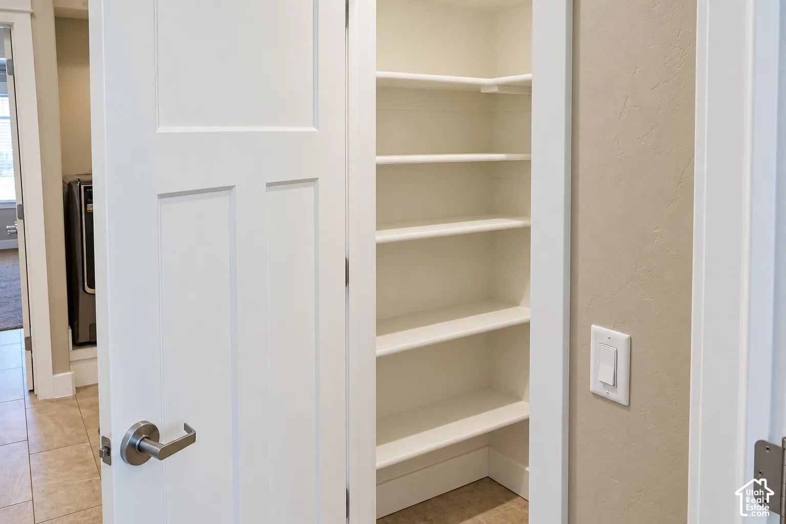 Built-in pantry shelving with white finishes