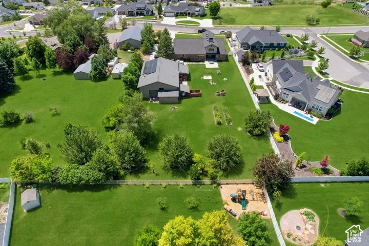 Expansive green landscape featuring mature trees and a manicured lawn