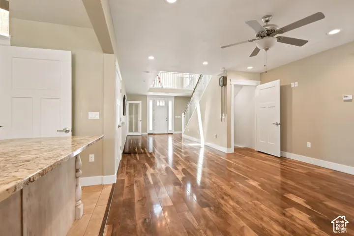 Spacious interior featuring wood-finish flooring, recessed lighting, and a ceiling fan