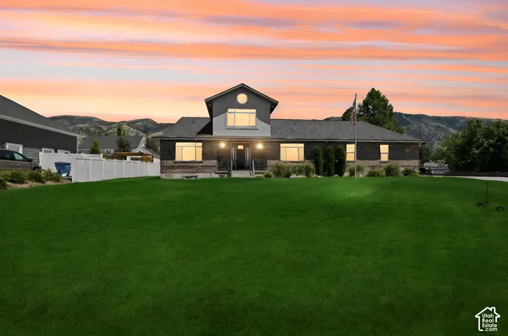 Contemporary residence featuring a brick and siding exterior, a prominent front gable, and a covered entry porch  Digitally staged.