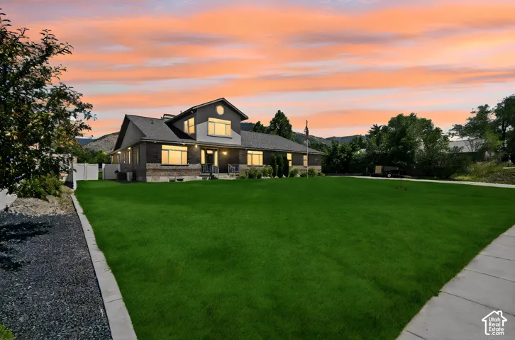 Expansive front lawn with a concrete pathway leading to the main entrance.  Digitally staged.