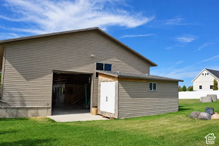 Two-story auxiliary building with horizontal siding and a large bay door