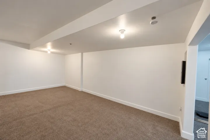 Neutral wall paint, recessed lighting, and carpeted flooring
