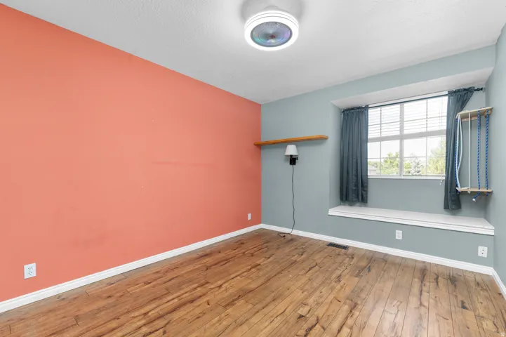 Wood-finish flooring, recessed window, and a window seat with built-in storage