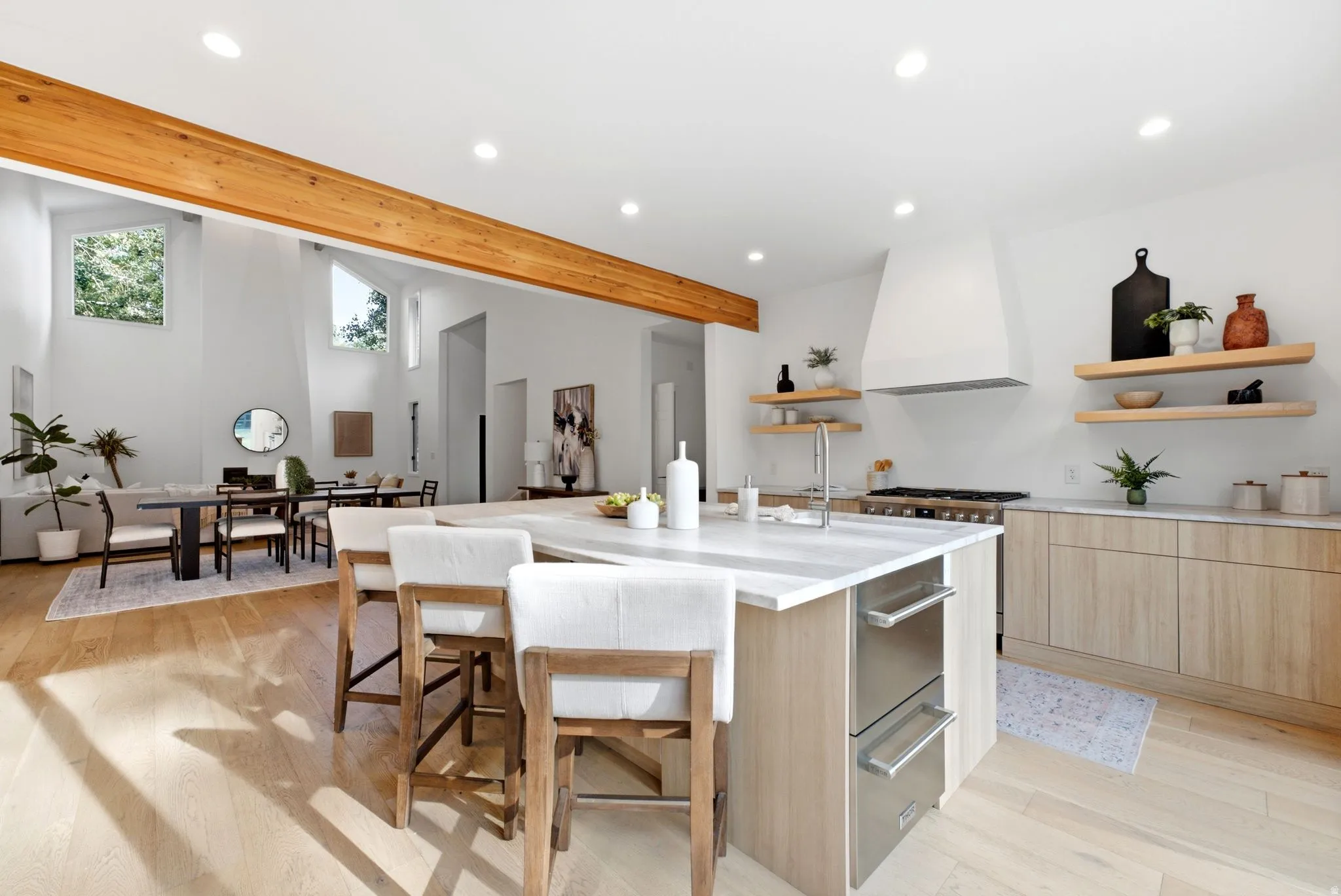 Kitchen island with a light-toned countertop and integrated stainless steel drawers