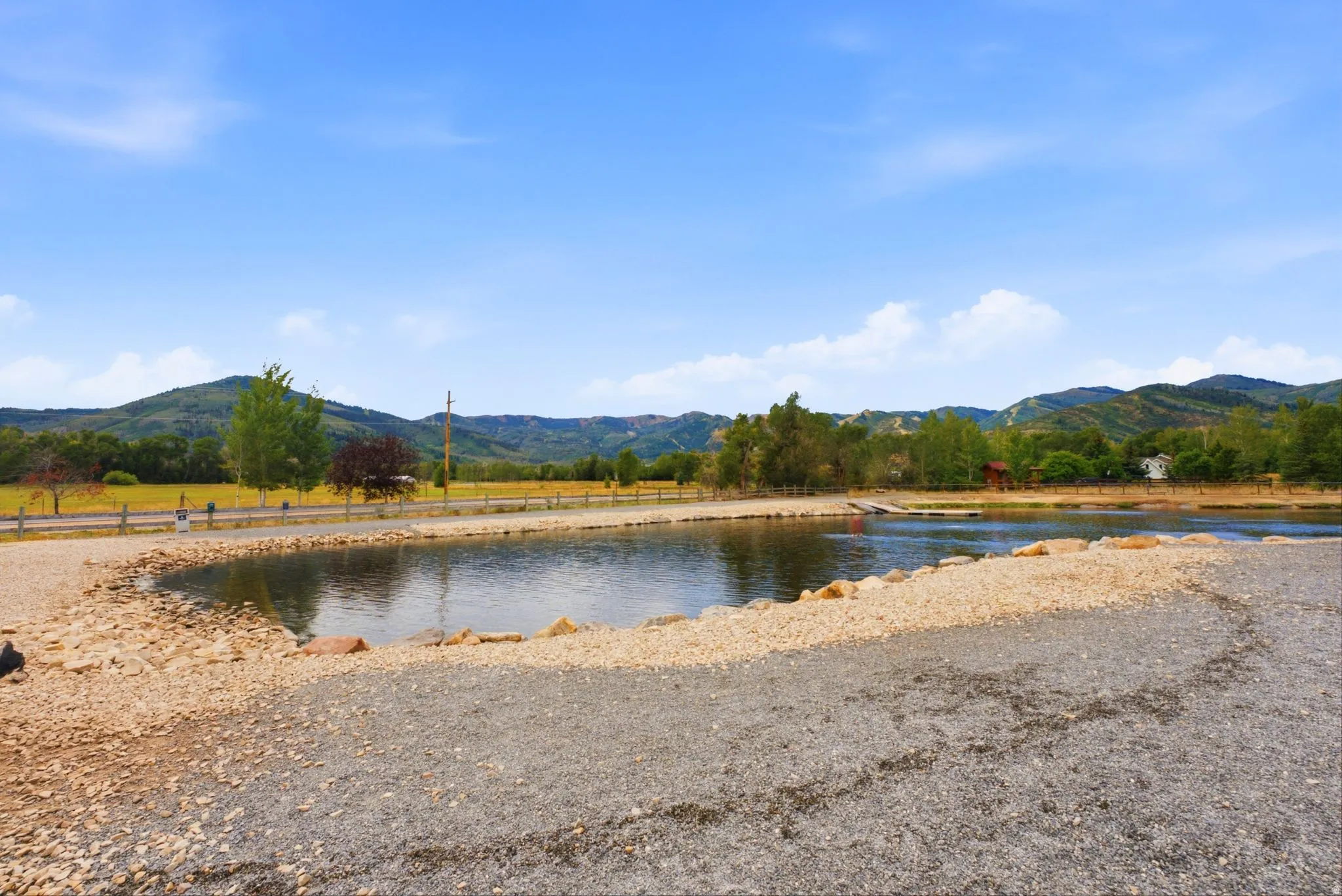 Expansive water feature with a stone and gravel shoreline