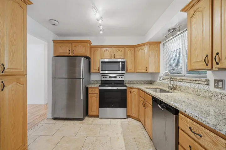 Kitchen with stainless steel appliances, refrigerator stays!