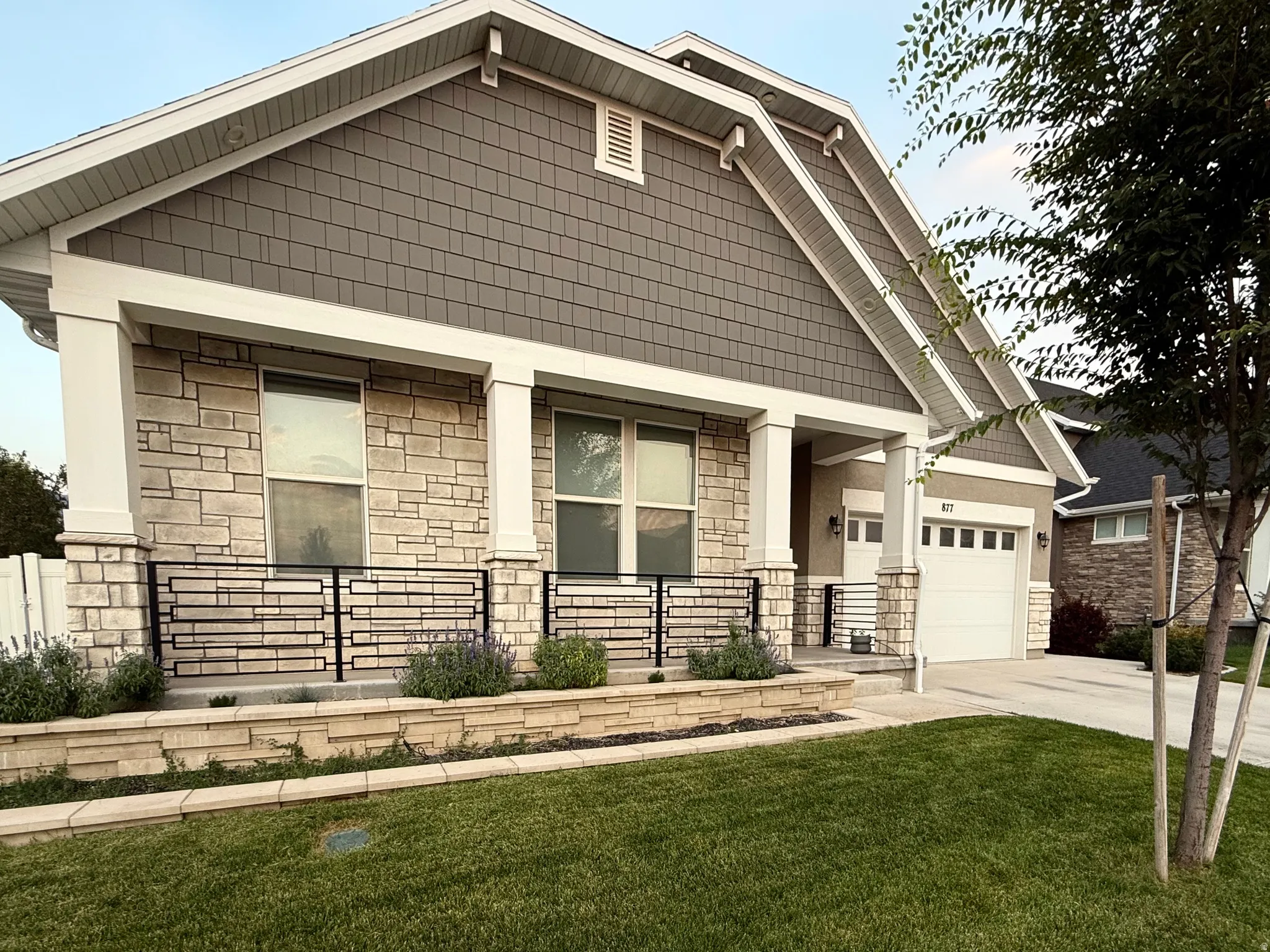 Stone and shake siding facade with a covered porch