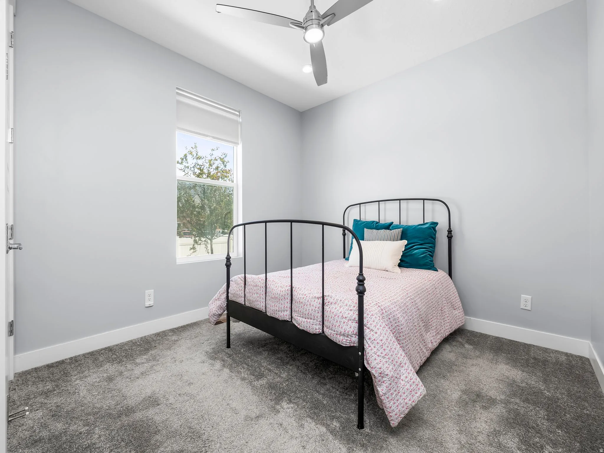Neutral gray walls complement the textured gray carpet flooring