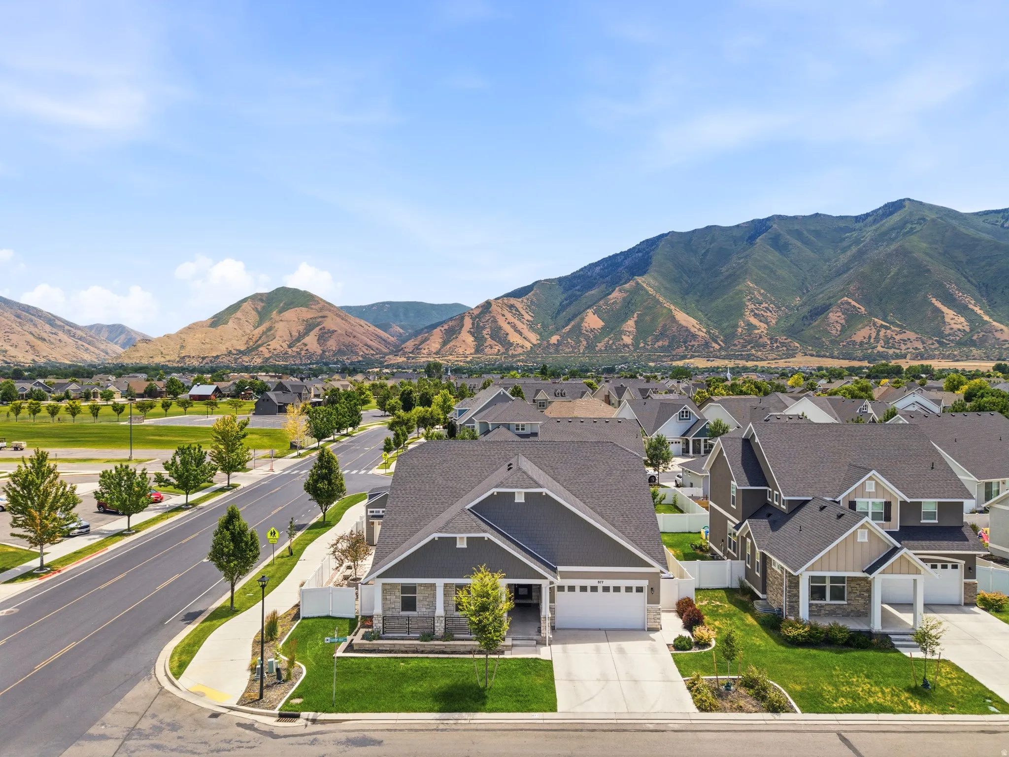 Contemporary ranch-style residence featuring a prominent front-facing garage