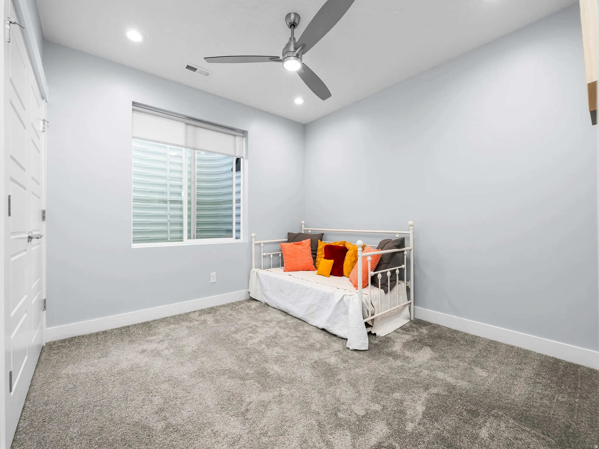 Room featuring plush grey carpeting, light grey walls, and recessed lighting