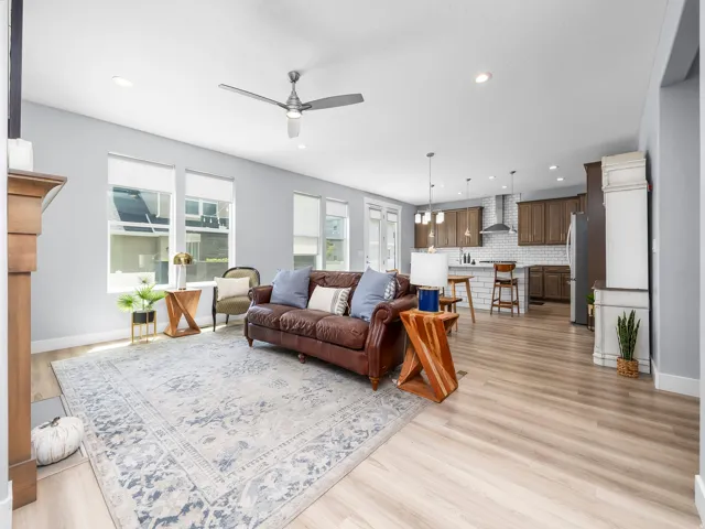 Open-concept living space featuring wood-finish flooring, recessed lighting, and a ceiling fan