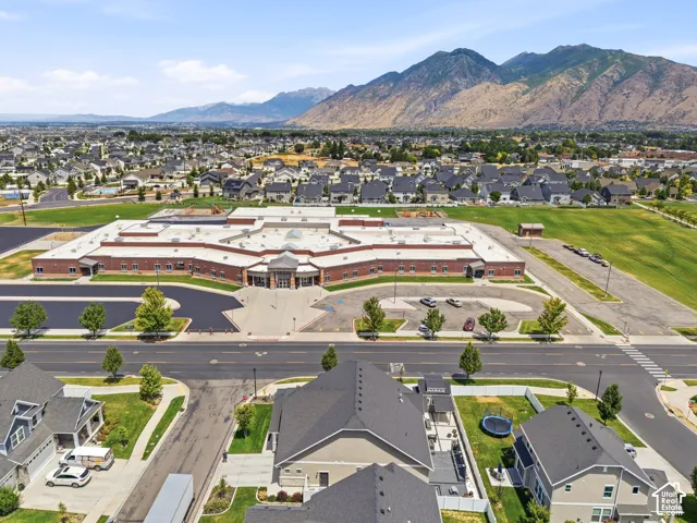 Expansive community featuring modern residential architecture and a large institutional building with brick and stone accents