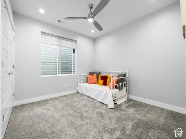 Room featuring plush grey carpeting, light grey walls, and recessed lighting