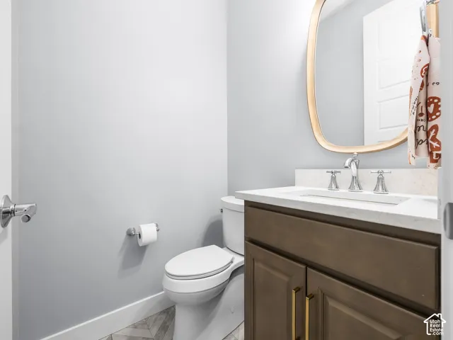 Bathroom vanity with a light-colored countertop, undermount sink, and chrome fixtures