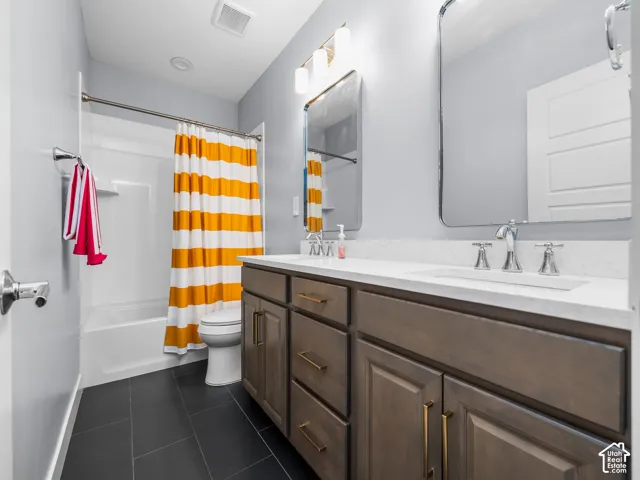 Bathroom featuring a single vanity with a white countertop, chrome faucet, and rectangular mirror