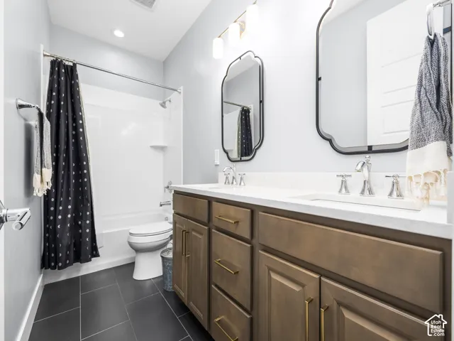 Dual vanity featuring a white countertop, undermount sinks, and bronze-finish hardware