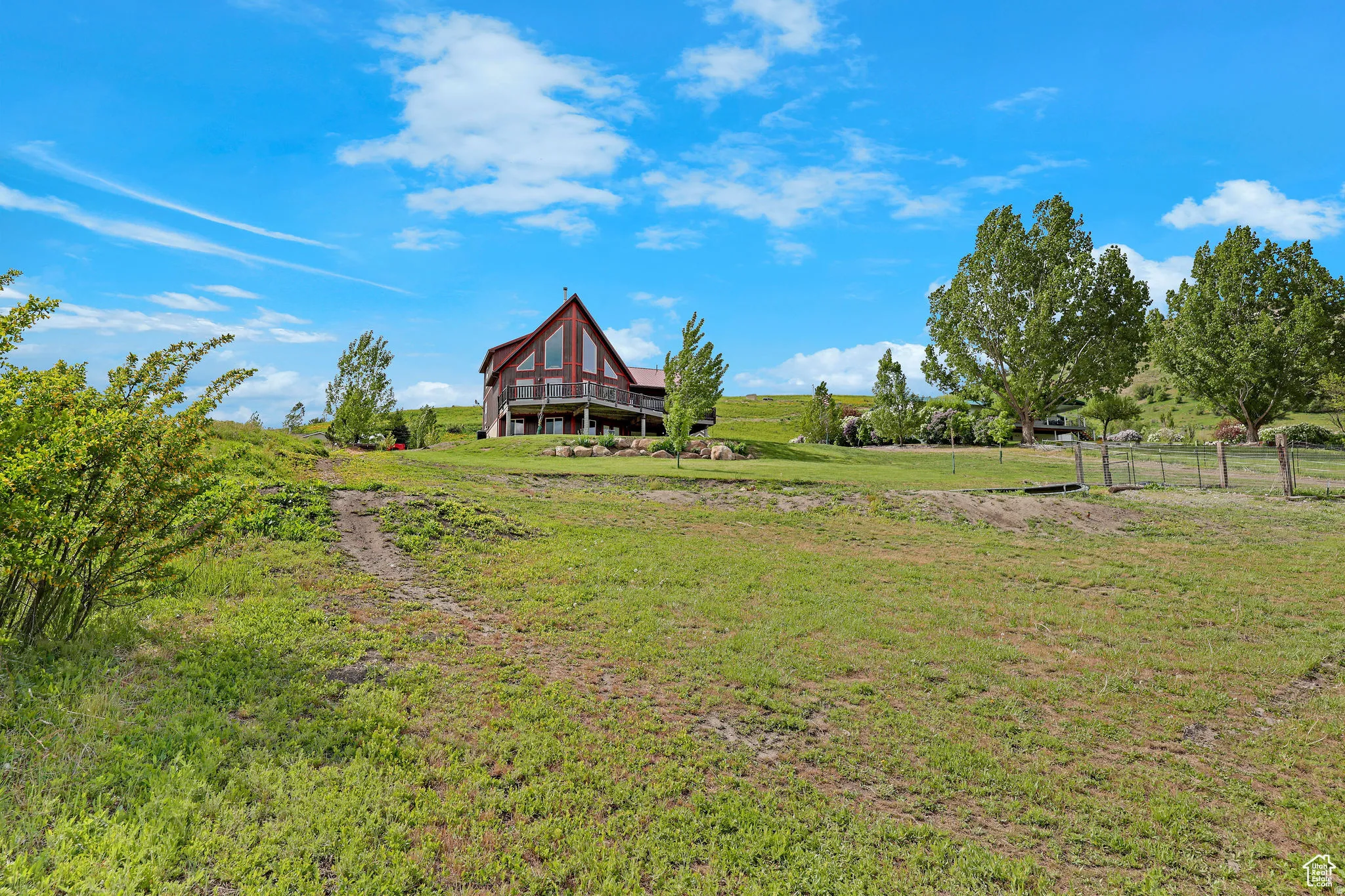 A-frame residence with a wood-sided exterior, expansive windows, and a multi-level deck