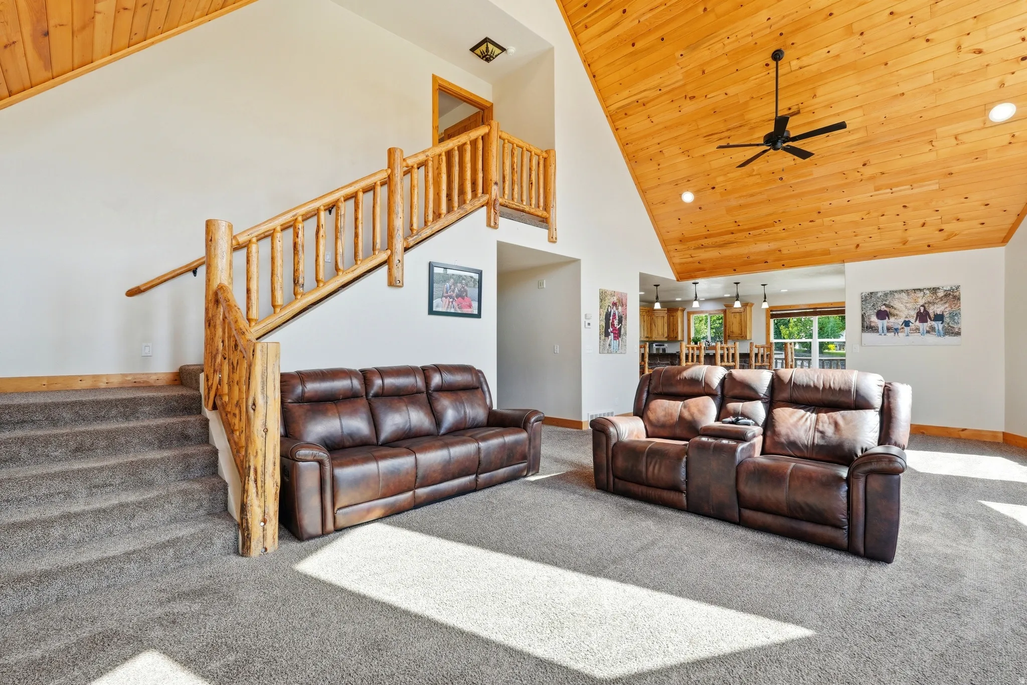 Vaulted wood-paneled ceiling with recessed lighting and a ceiling fan