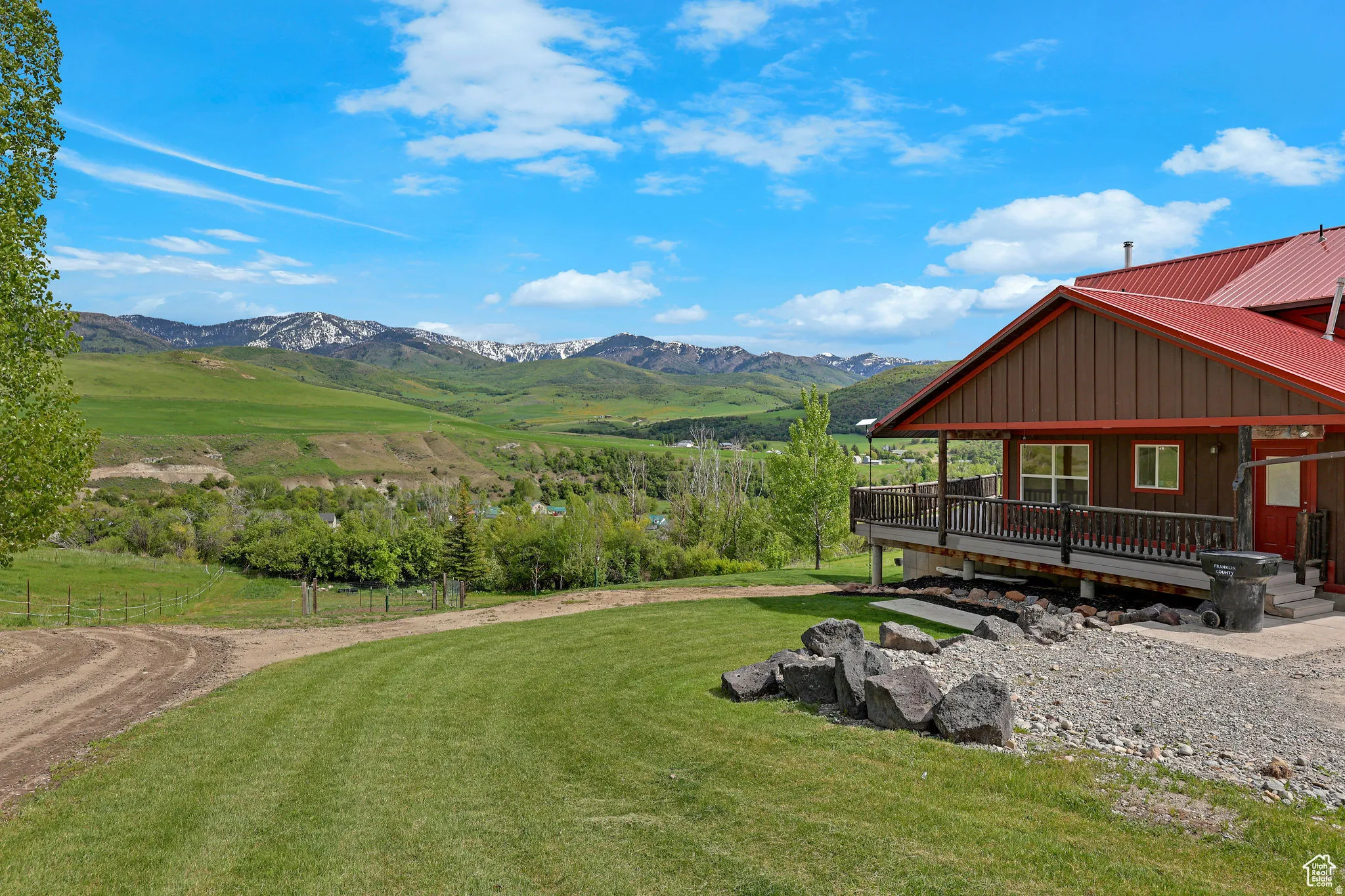 Expansive green landscape with distant snow-capped mountains
