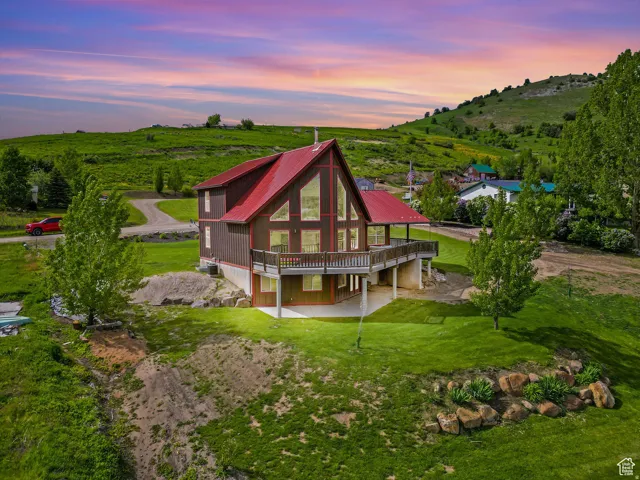Contemporary A-frame residence featuring a red metal roof and extensive window walls