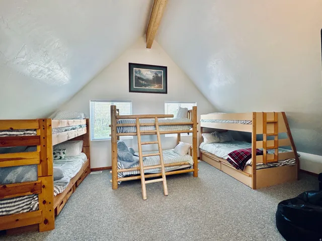 Attic room with sloped ceilings and exposed wood beam