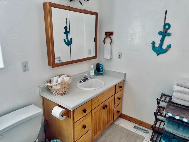 Bathroom vanity with wood cabinetry and a laminate countertop