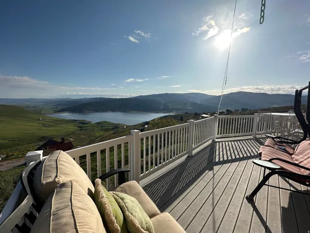 Spacious outdoor deck featuring composite decking and a white railing system