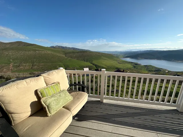 Expansive outdoor deck featuring composite flooring and white railing