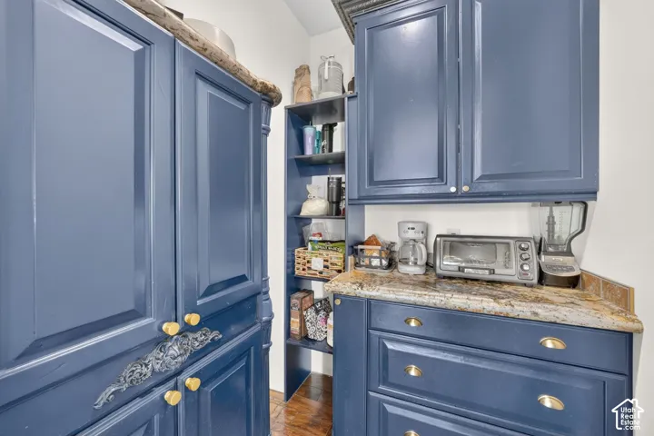 Custom cabinetry with blue painted finishes and gold-tone hardware