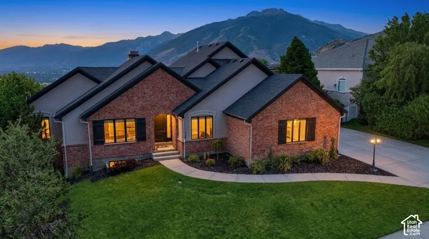 Stucco and brick exterior with dark shutters