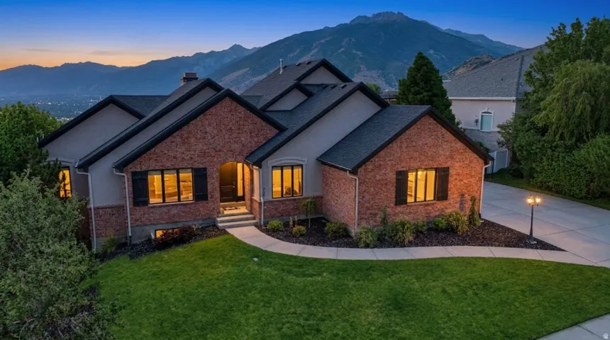 Stucco and brick exterior with dark shutters